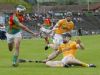 Antrim full-bac Cormac Donnelly flicks the ball away from Carlow's Craig Doyle as Chris McGuinness closes in during Saturday's All Ireland Hurling Qualifier at Casement Park. 