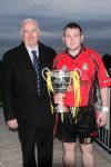 Kevin Armstrong jnr presents the Kevin Armstrong Memorial Cup to Ahoghill captain, Chris McGlone