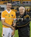 Ulster Council committee member Michael Hasson presents the Man of the Match to Antrim corner-back James McCuoig
