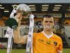 Antrim catpain Conor McCann lifts teh Under 21 Cup after his team's win over Armagh.