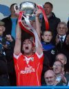 Loughgiel captain Johnny campbell lifts the Volunteer Cup after his team's win over Cushendall in Sunday's Antirm Senior Hurling final at Casement Park. Pic by Seamus Loughran