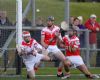 Loughgiel goalkeeper DD Quinn saves a goal bound shot by Dunloy's Paddy Richmond (out of picture) as team-mates Paul Gillan and Barney McAuley watch the breaking ball  during Sunday evening SHC semi-final in Ballycastle. 
