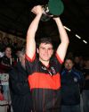 Cross & Passion captain Matthew Donnelly lifts the Mageean Cup after his team's win over St Mary's in Friday night's final at Casement Park.