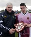 North Antrim chairman James McLean presents the Norht Antrim Feile na nGael skills trophy to Cushendall's Christy McNaughton. Pic by John McIlwaine