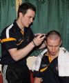  Michael McCann shows his hairdressing skills as he 'shears' Antrim team-mate Paul Doherty. Pic by John McIlwaine