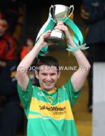 Creggan captain Niall Robb lifts the Junior Hurling Championship cup after his team's win over Glenravel in Sunday's final at Casement Park. 