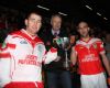 Team captain Johnny Campbell (right) and vice-captain DD Quinn receive the Four Season Cup from Ulster vice-chairman Martin McAviney after their team's win over Ballycran in dreadful weather conditions at Casement Park.