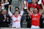 Team captain Johnny Campbell and vice-captain DD Quinn lift the Tommy Moore Cup after their team's win over Coolderry 