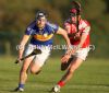 Rossa's Conor Rocks is challenged by Loughgiel captain Johnny Campbell during Friday evening's Senior Hurling Championship opener in Glenravel