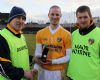 Barry McFall receives the man of the match award, sponsored by county sponsors Creagh Concrete, from team manager Dinny Cahill and his assistant Gregory O'Kane