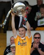 Antrim captain Paul Shiels raises the Liam Harvey Cup after his team's win over Down in the Ulster Senior Hurling final at Casement Park