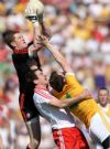 Tyrone goalkeeper Pascal McConnell catches a high ball in the square as Full-back Juston McMahon gets to grips with Antrim's Michael McCann