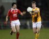 Man of the match James Loughrey in action against Louth's Brian White during last night's win at Casement Park. Pic by John McIlwaine