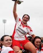 Player fo the match Racquel McCarry is lifted shoulder high by her team-mates after Sunday's Antrim Senior Camogie final in Casement Park. 