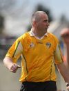 Team Coach Paul McKillen proudly wears the Antrim colours as he strides the sideline.