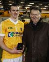 Gerard McKeague of county sponsors Creagh Concrete presetns the man of the match award to Antrim corner-back Dermot McCann after his teams win over Fermanagh