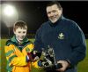 Sean Fleming (Antrim Coaching Officer) presents the Year 8 trophy to St. Mary's captain Conor O'Rawe