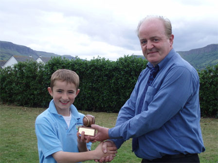 Mr. McKillop presenting Conor Patterson with the Hurling Skills individual trophy